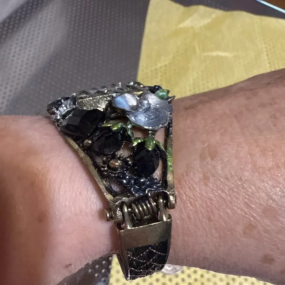 vintage-style floral women's cuff watch with a square face and black and silver-